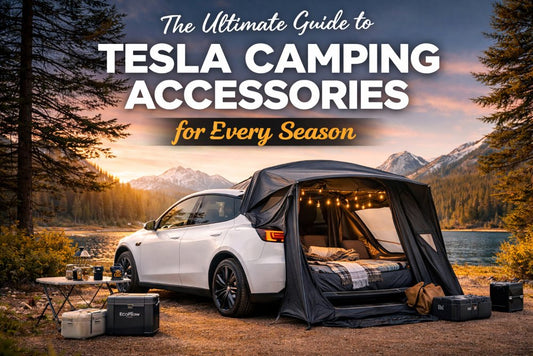 Tesla Model Y parked by a lake with a tailgate tent, cozy bedding, and camping gear, set against a sunset backdrop of snow-capped mountains.
